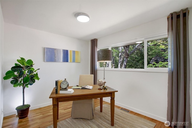 9030 6th Ave NW, Seattle, WA 98117 - home office with baseboards and light wood-style flooring