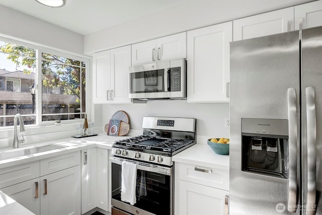 6128 202nd St SW Unit 101, Lynnwood, WA 98036 - kitchen with appliances with stainless steel finishes, light countertops, and white cabinets