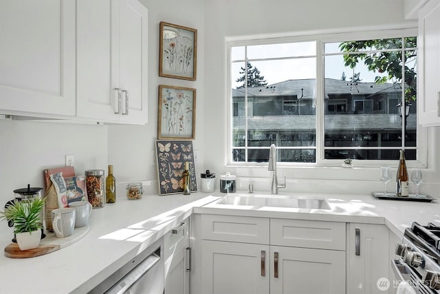 6128 202nd St SW Unit 101, Lynnwood, WA 98036 - kitchen featuring healthy amount of natural light, white cabinets, and light countertops