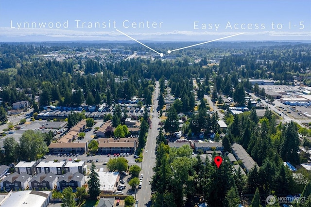6128 202nd St SW Unit 101, Lynnwood, WA 98036 - aerial view of property and surrounding area featuring a heavily wooded area
