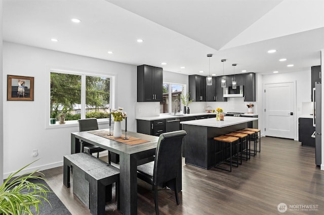 16100 SE 113th Pl, Renton, WA 98059 - dining space with dark wood-style floors, recessed lighting, vaulted ceiling, and baseboards