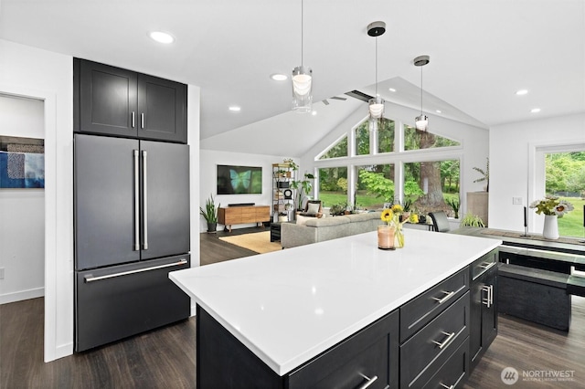 16100 SE 113th Pl, Renton, WA 98059 - kitchen with high end fridge, lofted ceiling, dark wood-style flooring, dark cabinetry, and light countertops