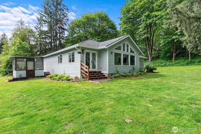 16100 SE 113th Pl, Renton, WA 98059 - rear view of property with french doors, a lawn, a sunroom, and view of wooded area