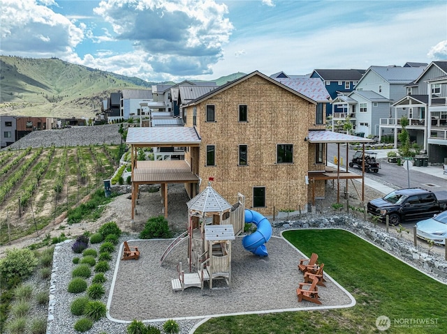 203 Bluebell Ct, Chelan, WA 98816 - back of property featuring a mountain view, a residential view, and a playground