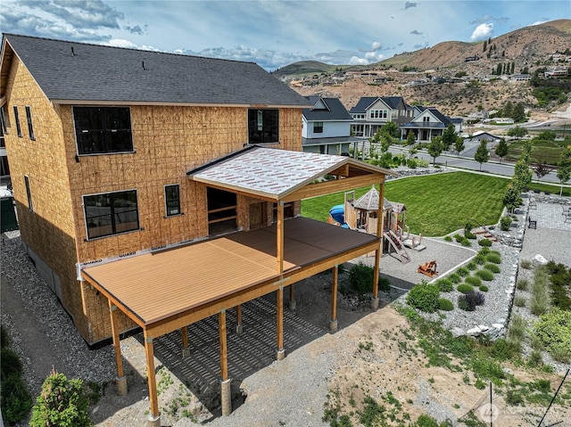 203 Bluebell Ct, Chelan, WA 98816 - back of property featuring roof with shingles and a deck with mountain view