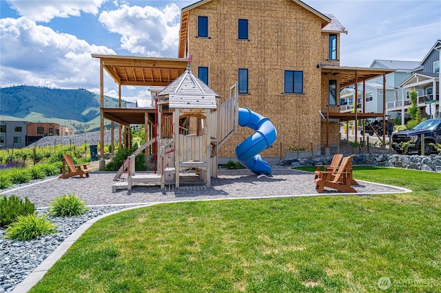 203 Bluebell Ct, Chelan, WA 98816 - communal playground with a mountain view, a lawn, and a patio area