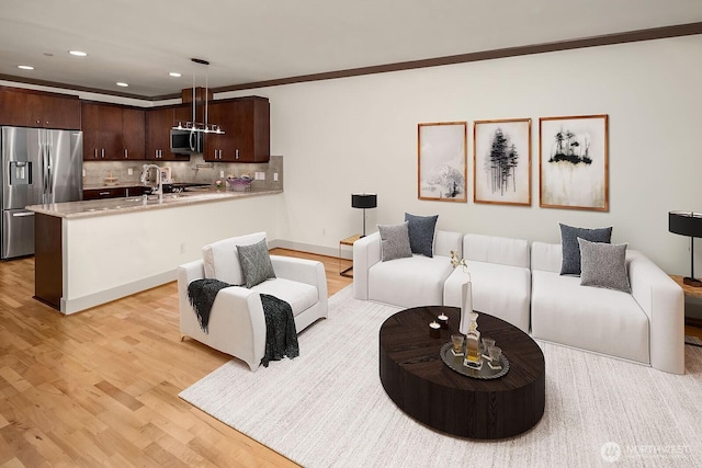 18609 SE Newport Way Unit 408, Issaquah, WA 98027 - living room featuring light wood-style flooring, recessed lighting, and crown molding