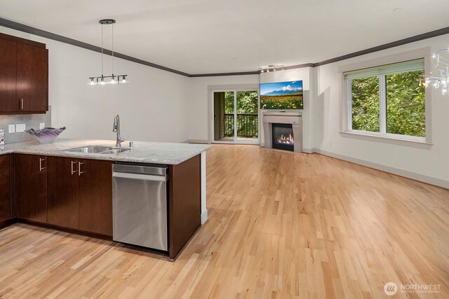 18609 SE Newport Way Unit 408, Issaquah, WA 98027 - kitchen with a sink, stainless steel dishwasher, crown molding, light wood-type flooring, and a peninsula