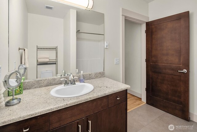 18609 SE Newport Way Unit 408, Issaquah, WA 98027 - bathroom with vanity and tile patterned floors