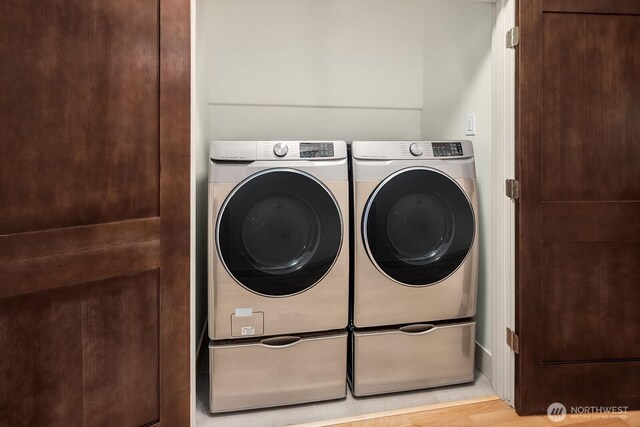 18609 SE Newport Way Unit 408, Issaquah, WA 98027 - laundry area featuring independent washer and dryer and light wood-style flooring