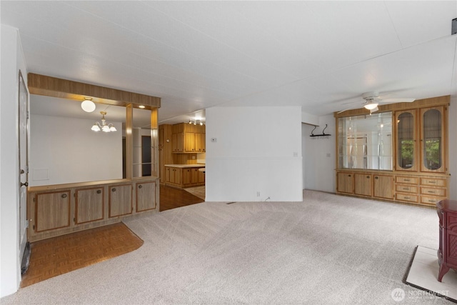 11216 127th St E Unit 19, Puyallup, WA 98374 - unfurnished living room with a chandelier, ceiling fan, and carpet flooring