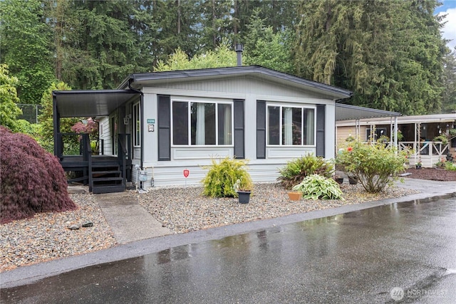 11216 127th St E Unit 19, Puyallup, WA 98374 - manufactured / mobile home with covered porch and an attached carport