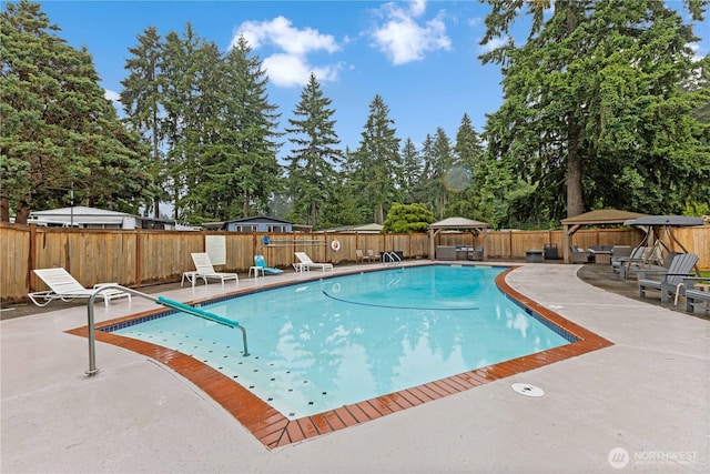 11216 127th St E Unit 19, Puyallup, WA 98374 - view of pool with a gazebo, a patio area, a fenced backyard, and view of wooded area