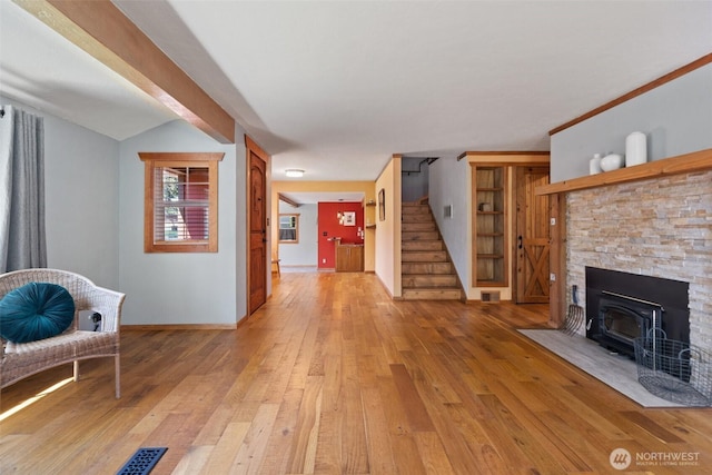 2526 19th St, Bremerton, WA 98312 - living area featuring light wood-type flooring, stairs, baseboards, and a wood stove
