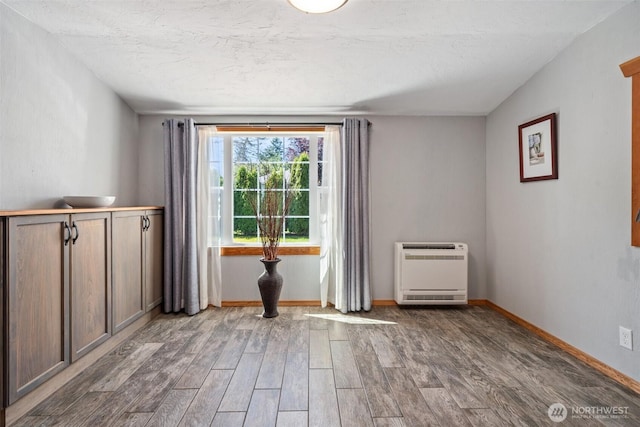 2526 19th St, Bremerton, WA 98312 - unfurnished room featuring heating unit, wood finished floors, and baseboards