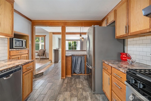 2526 19th St, Bremerton, WA 98312 - kitchen with appliances with stainless steel finishes, tasteful backsplash, dark wood-style flooring, and range hood