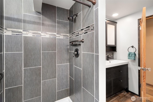 2526 19th St, Bremerton, WA 98312 - bathroom featuring a tile shower, wood finished floors, and vanity