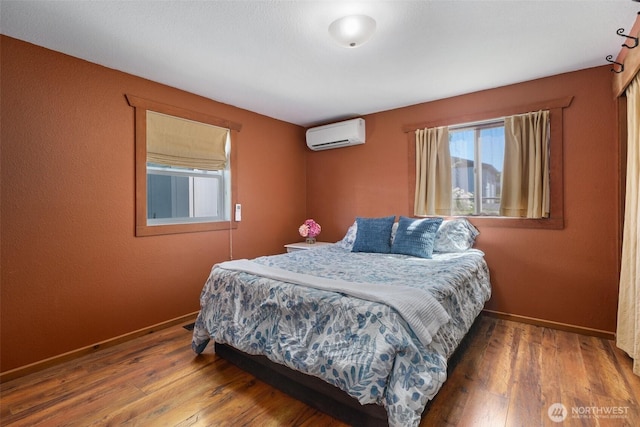 2526 19th St, Bremerton, WA 98312 - bedroom with a wall mounted air conditioner, wood finished floors, and baseboards