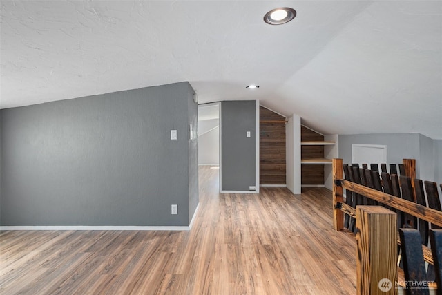2526 19th St, Bremerton, WA 98312 - bonus room featuring wood finished floors, lofted ceiling, and baseboards