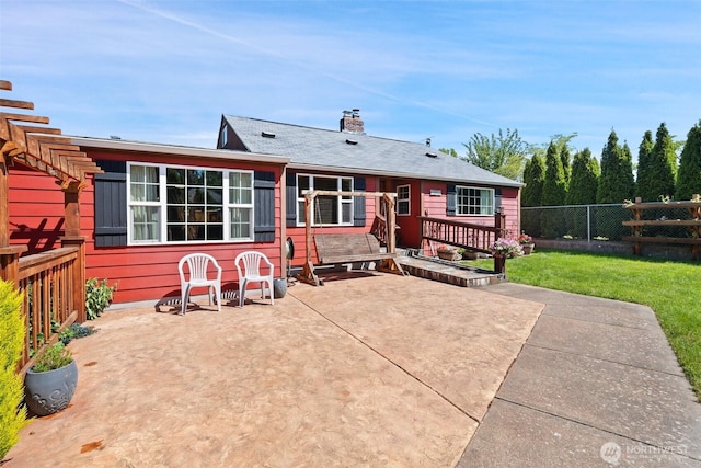 2526 19th St, Bremerton, WA 98312 - rear view of house featuring a patio area, a wooden deck, and a chimney