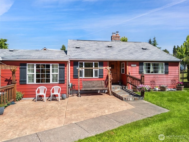 2526 19th St, Bremerton, WA 98312 - rear view of house featuring a chimney, a yard, and a patio