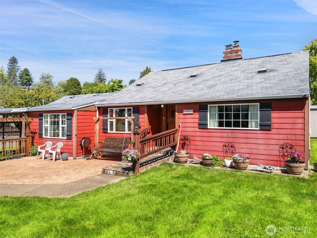 2526 19th St, Bremerton, WA 98312 - view of front of home with a front yard, a patio, a chimney, a shingled roof, and a deck