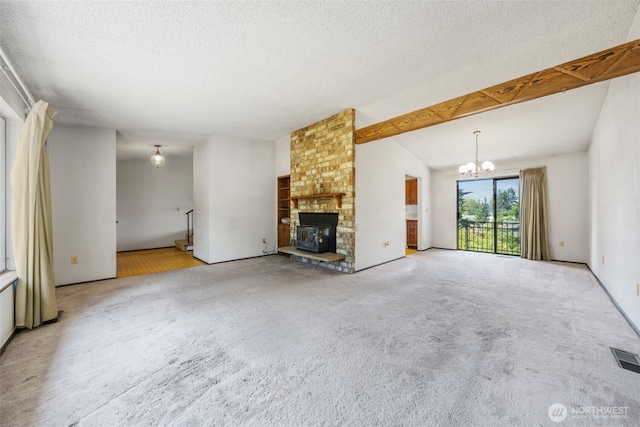 1015 143rd St S, Tacoma, WA 98444 - unfurnished living room with a chandelier, a textured ceiling, a brick fireplace, carpet, and vaulted ceiling