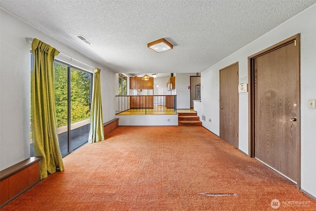 1015 143rd St S, Tacoma, WA 98444 - kitchen with carpet, a textured ceiling, and brown cabinets