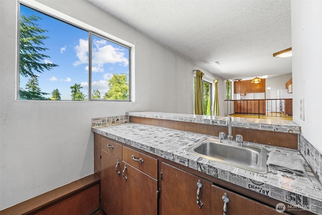1015 143rd St S, Tacoma, WA 98444 - kitchen with a sink, a textured ceiling, and light countertops