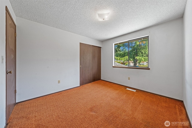 1015 143rd St S, Tacoma, WA 98444 - unfurnished bedroom with carpet, a textured ceiling, and a closet