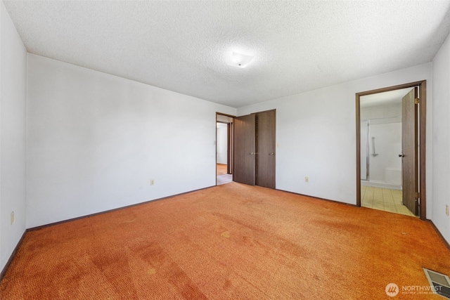 1015 143rd St S, Tacoma, WA 98444 - unfurnished bedroom with carpet floors, ensuite bathroom, and a textured ceiling