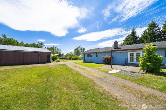 1119 Sunset Ave, Bellingham, WA 98226 - view of grassy yard with french doors, an outbuilding, dirt driveway, and an outdoor structure