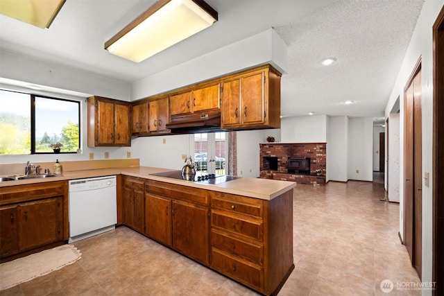 1119 Sunset Ave, Bellingham, WA 98226 - kitchen with dishwasher, black electric stovetop, under cabinet range hood, a peninsula, and brown cabinetry