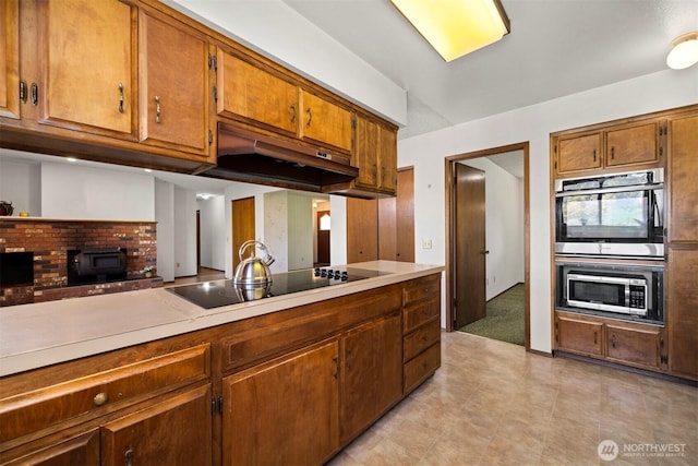 1119 Sunset Ave, Bellingham, WA 98226 - kitchen featuring black electric stovetop, under cabinet range hood, double oven, light countertops, and light tile patterned floors