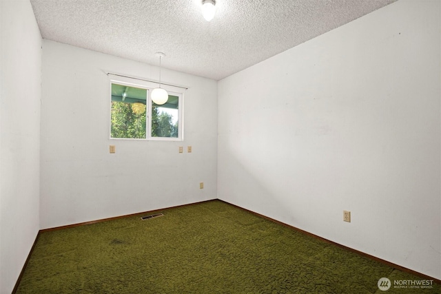 1119 Sunset Ave, Bellingham, WA 98226 - unfurnished room featuring a textured ceiling and dark colored carpet