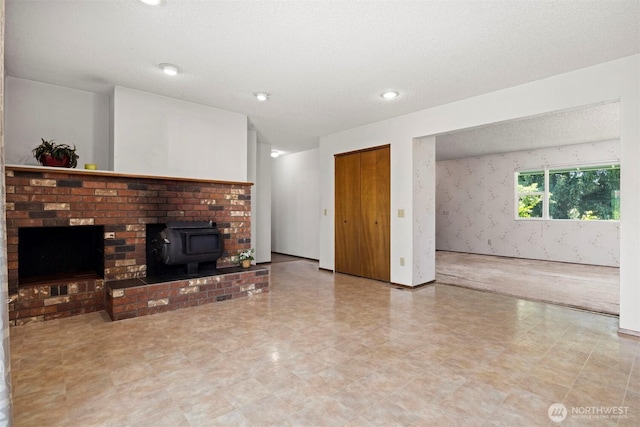 1119 Sunset Ave, Bellingham, WA 98226 - unfurnished living room with a wood stove, tile patterned floors, and a textured ceiling
