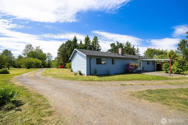 1119 Sunset Ave, Bellingham, WA 98226 - view of front of home with dirt driveway, a chimney, and a front lawn