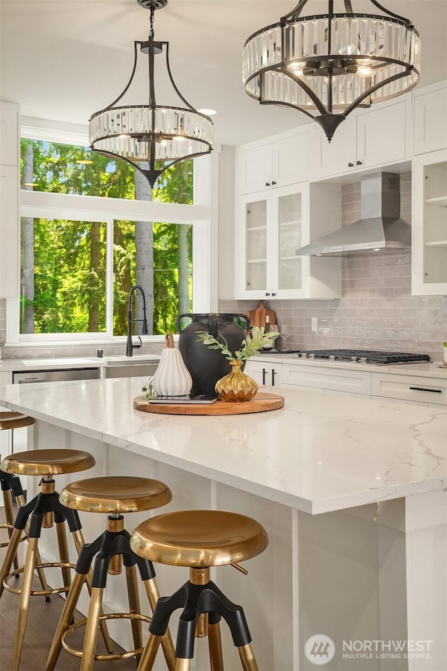 19722 Filbert Dr Unit A-3, Bothell, WA 98012 - kitchen featuring wall chimney range hood, backsplash, and plenty of natural light