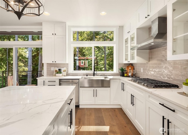 19722 Filbert Dr Unit A-3, Bothell, WA 98012 - kitchen featuring appliances with stainless steel finishes, wall chimney range hood, a sink, wood finished floors, and white cabinets