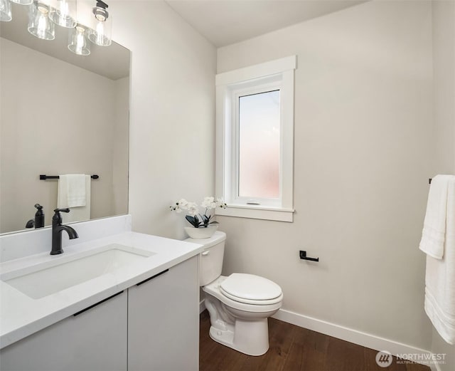 19722 Filbert Dr Unit A-3, Bothell, WA 98012 - half bath featuring baseboards, vanity, toilet, and wood finished floors