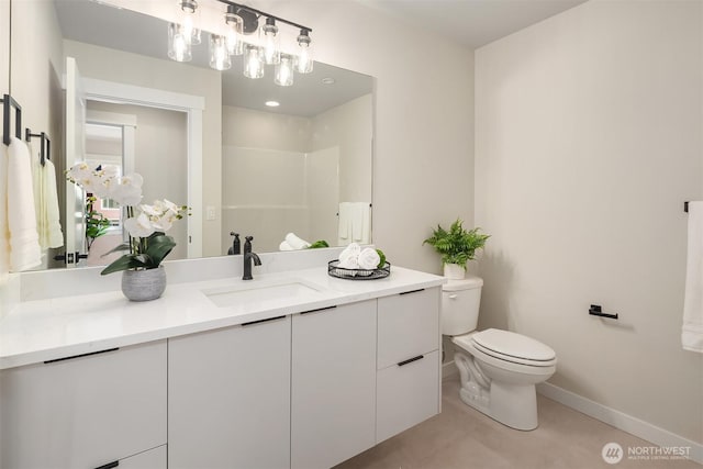 19722 Filbert Dr Unit A-3, Bothell, WA 98012 - bathroom featuring toilet, vanity, baseboards, tile patterned floors, and a shower