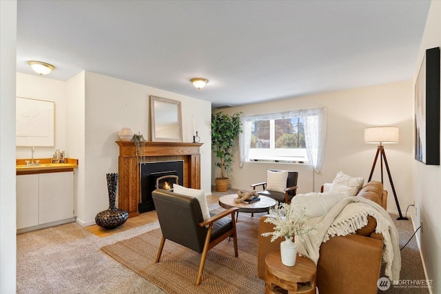 8225 212th St SW # 302, Edmonds, WA 98026 - living area with a tiled fireplace, light colored carpet, and baseboards