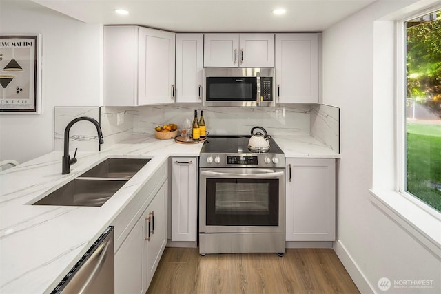 6202 122nd Ave SE, Bellevue, WA 98006 - kitchen with appliances with stainless steel finishes, light wood-style floors, tasteful backsplash, healthy amount of natural light, and recessed lighting