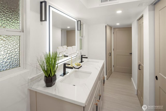 6202 122nd Ave SE, Bellevue, WA 98006 - bathroom with double vanity, wood finished floors, and recessed lighting