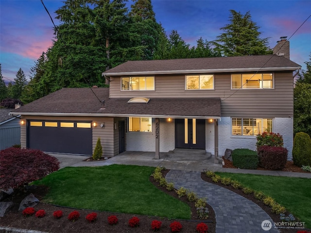 6202 122nd Ave SE, Bellevue, WA 98006 - traditional-style house with a front lawn, an attached garage, concrete driveway, a chimney, and brick siding