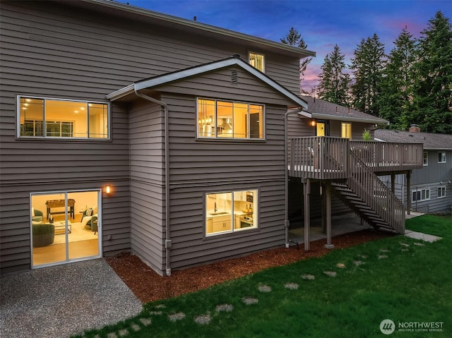 6202 122nd Ave SE, Bellevue, WA 98006 - back of property at dusk with a deck, stairs, and a yard