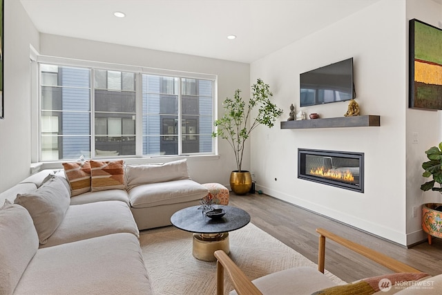 26627 NE Boyd Way Unit 101, Duvall, WA 98019 - living room featuring wood finished floors, a glass covered fireplace, baseboards, and recessed lighting