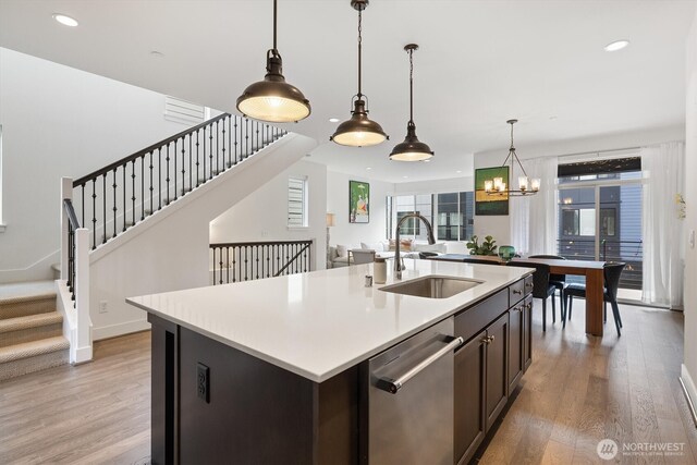26627 NE Boyd Way Unit 101, Duvall, WA 98019 - kitchen featuring stainless steel dishwasher, a sink, light wood-style floors, light countertops, and recessed lighting