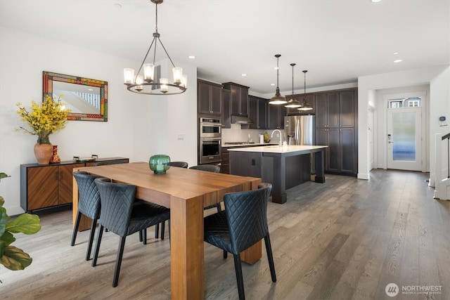 26627 NE Boyd Way Unit 101, Duvall, WA 98019 - dining area with a chandelier, light wood-style floors, recessed lighting, and baseboards