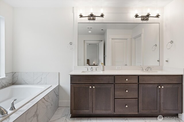 26627 NE Boyd Way Unit 101, Duvall, WA 98019 - full bathroom with double vanity, a tub with marble appearance, and marble finish floors